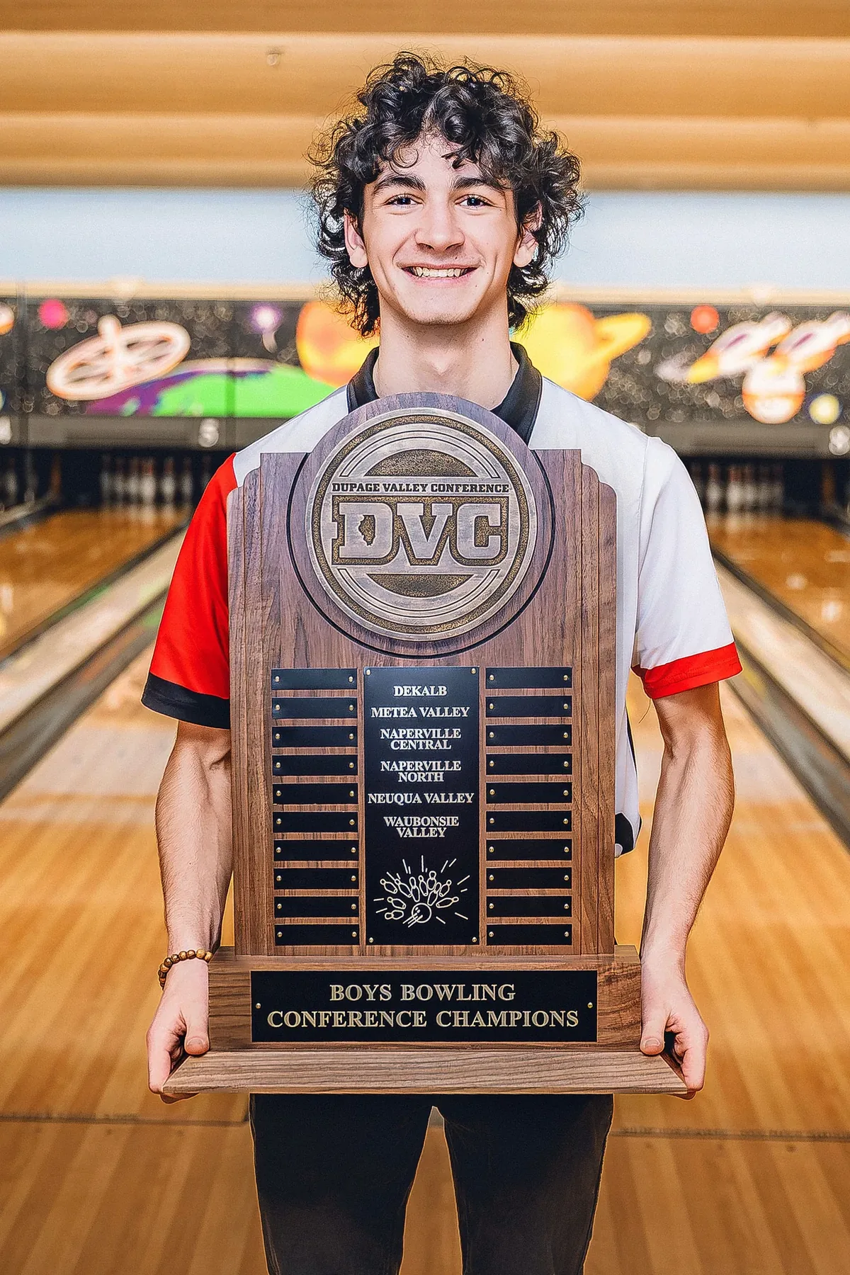 Sean Mulvey holding the DuPage Valley Conference Boys Bowling Champions trophy