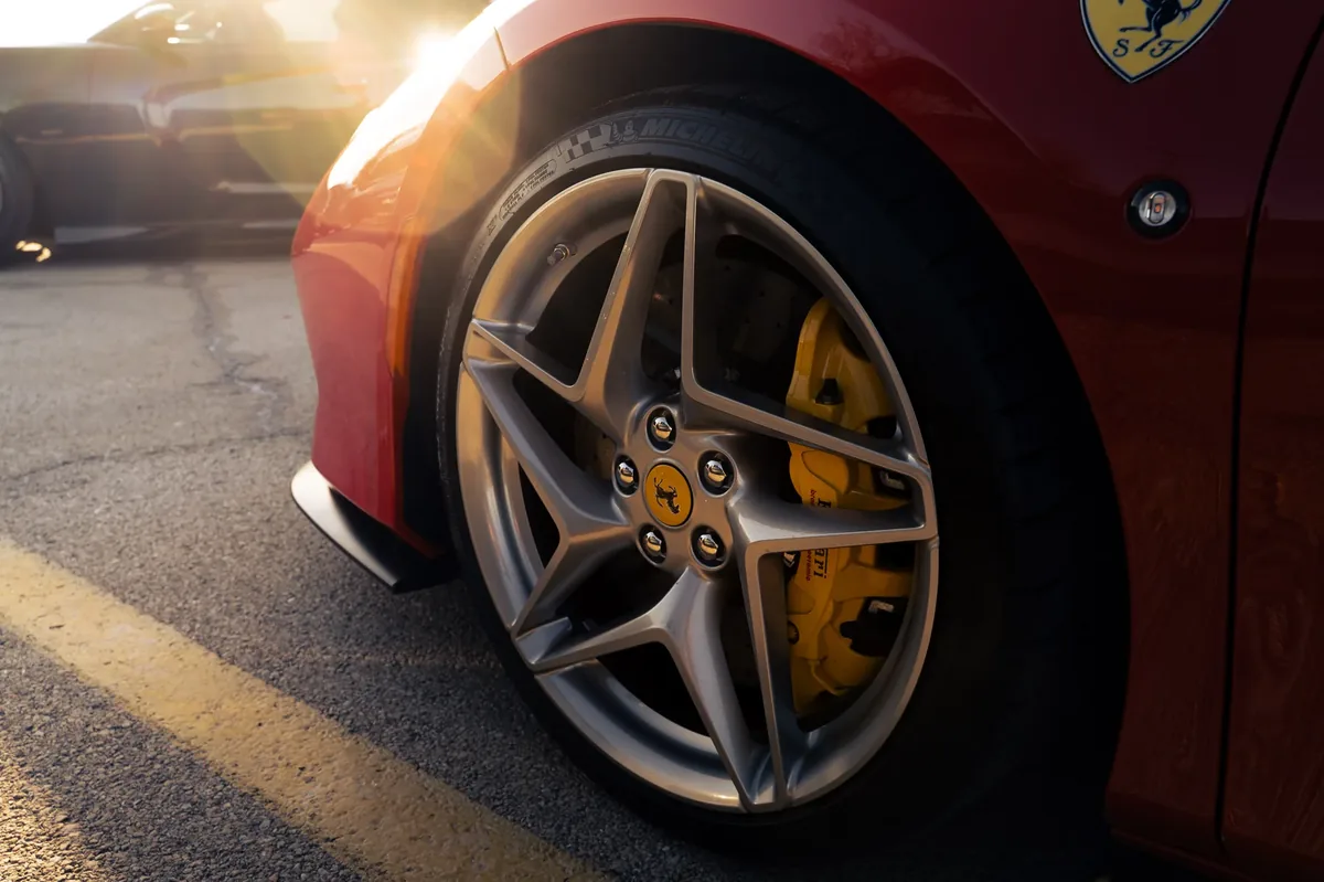 Ferrari wheel and brake caliper in golden light